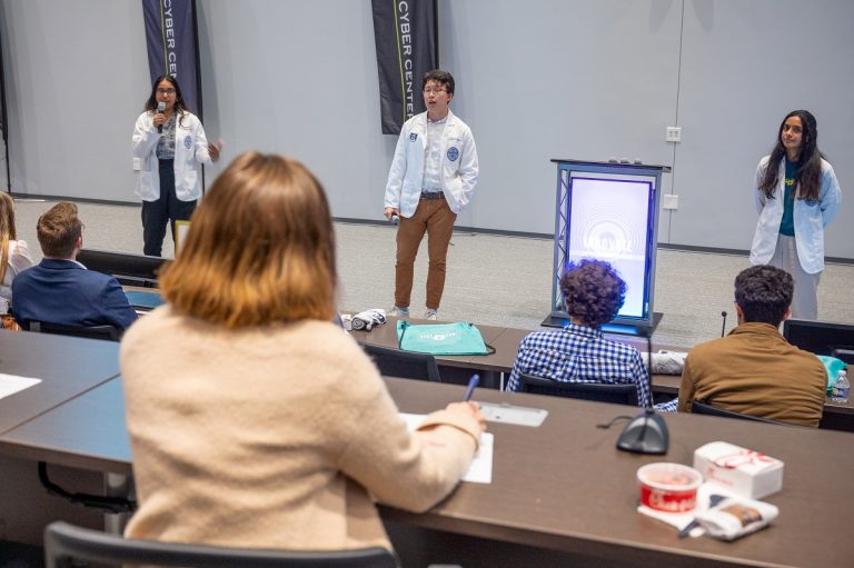 Young men and women give a presentation in front of judges