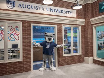 Mascot standing in the storefront