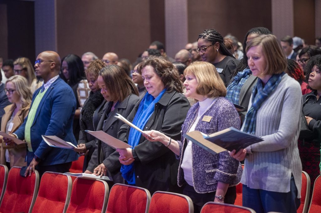 Audience members look at a program during a Martin Luther King Jr. celebration