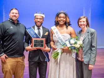 Mr. and Miss Augusta University standing with Augusta University staff members