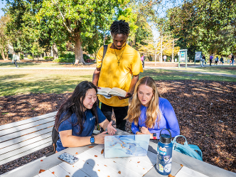 Three students looking at a computer on the Summerville Campus at Augusta University.