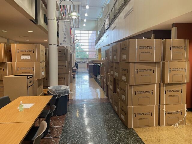 Large stacks of boxes line a hallway.