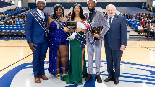 Past homecoming king and queen are with the new homecoming king and queen as well as the Augusta University president