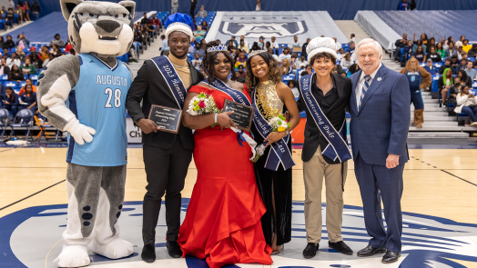 The 2023 Augusta University Homecoming Court stands with university mascot Augustus and President Brooks A. Keel, PhD.
