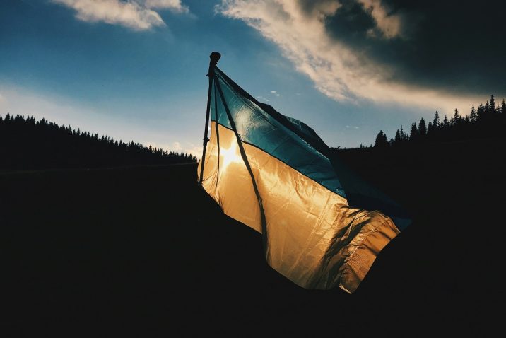 Ukraine flag with the sun in the back ground