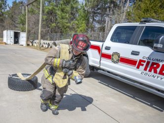 Firefighter dragging a tire