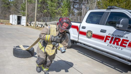 Firefighter dragging a tire