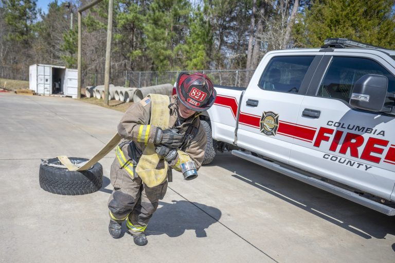 Firefighter dragging a tire