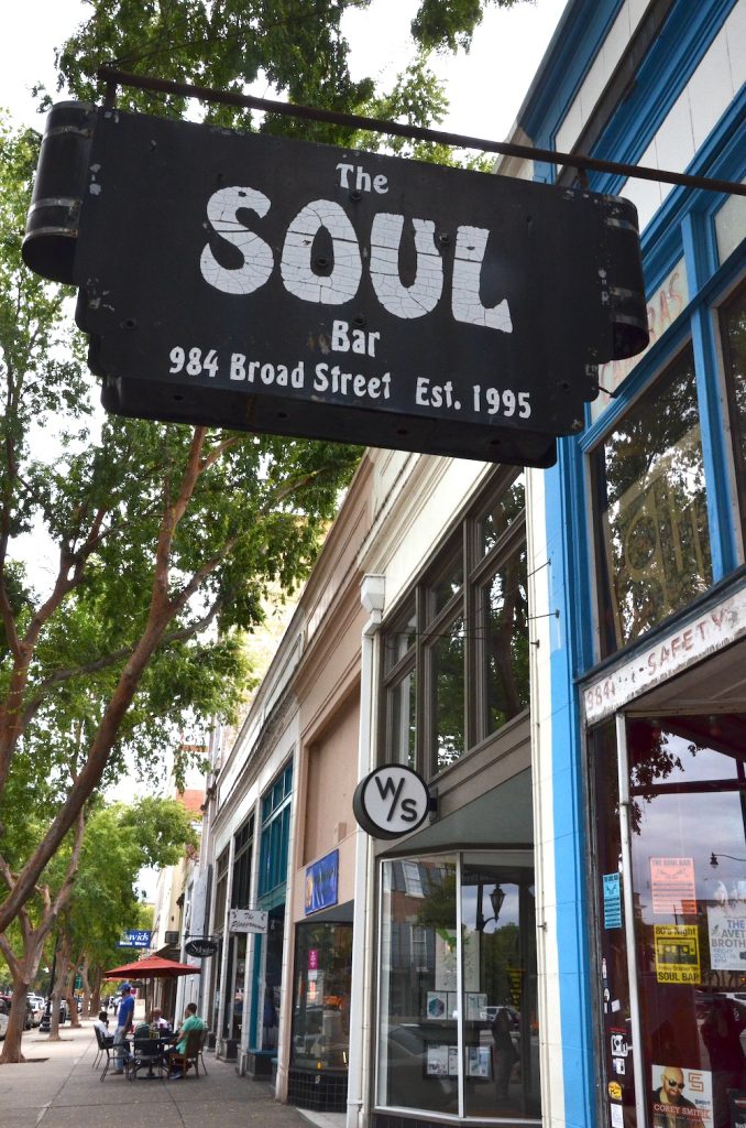 Picture of the sign for The Soul Bar -- A black sign with white lettering that says "The Soul Bar, 984 Broad Street Est. 1995"