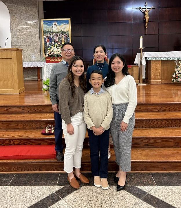 a family of 5 posing in a church