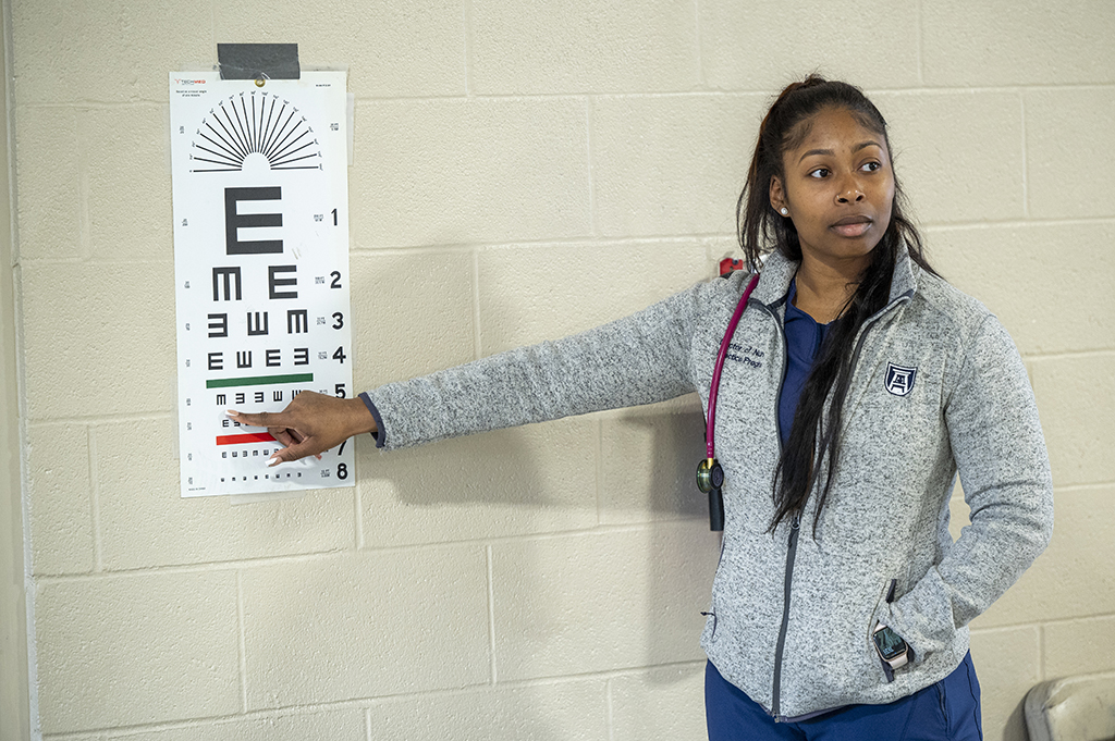 Woman pointing to an eye chart