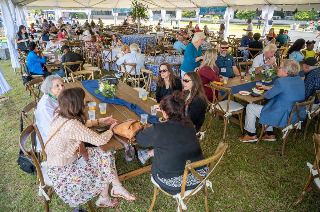 People under a tent talking and dining
