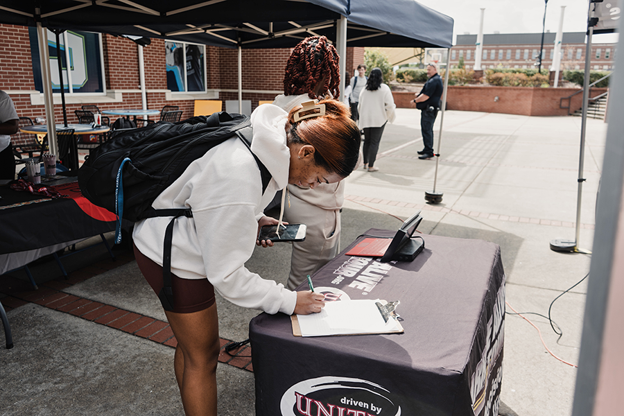 College students fill out information forms during a recent Arrive Alive Tour stop on a college campus.