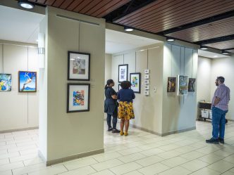 Men and women check out art on display
