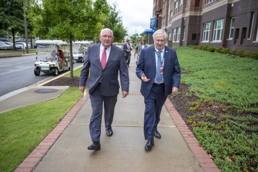 University System of Georgia President Sonny Perdue walks with Augusta University President Brooks, A. Keel