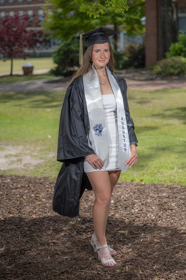 Woman smiling in cap and gown