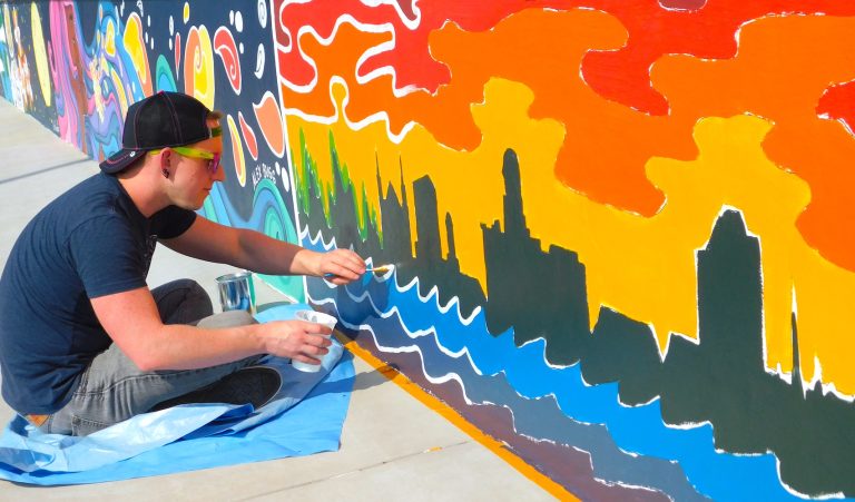 man painting mural