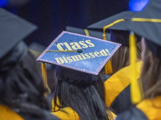 A graduation cap with the words "Class Dismissed!" written on it.