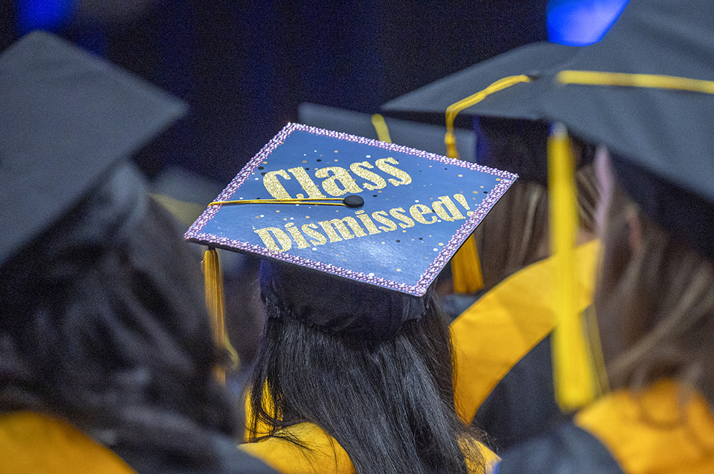 A graduation cap with the words "Class Dismissed!" written on it.