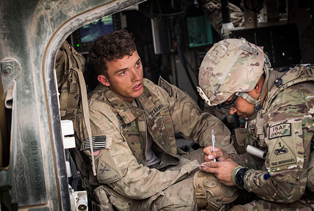 Soldier receives aid sitting in helicopter