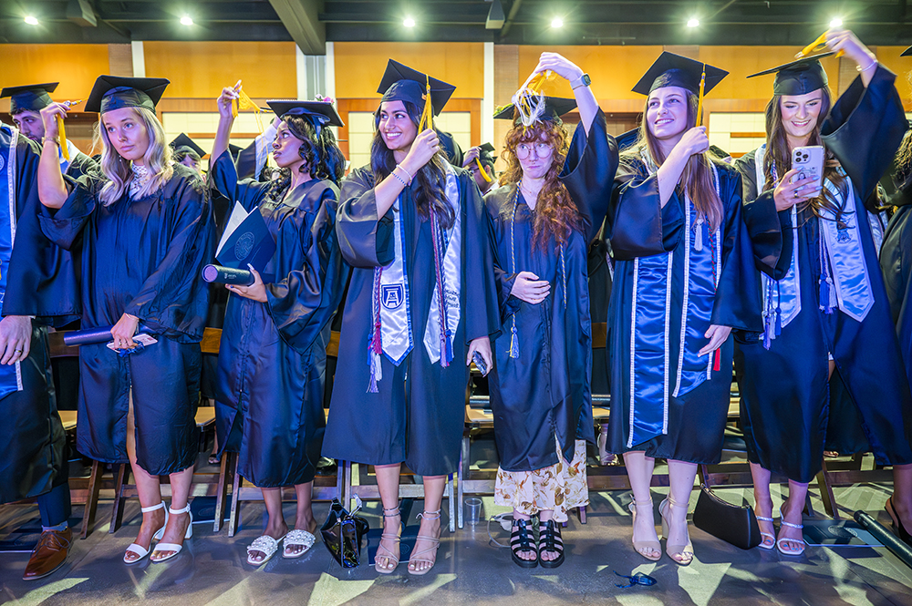 College graduates move their tassels from right to left to signify they have officially graduated.