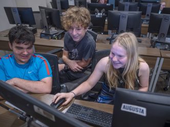 Young students work on a computer during animation camp