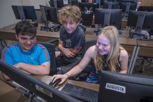 Young students work on a computer during animation camp