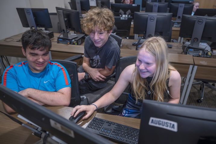 Young students work on a computer during animation camp