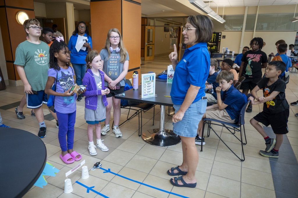 A camp instructor at the VICROY Summer Kids camp gives directions during a competition.