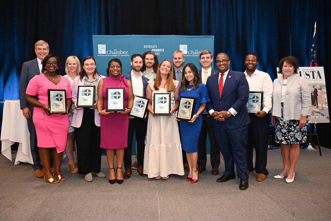 Large group of people holding awards.