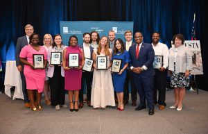 Large group of people holding awards.