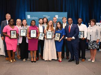 Large group of people holding awards.