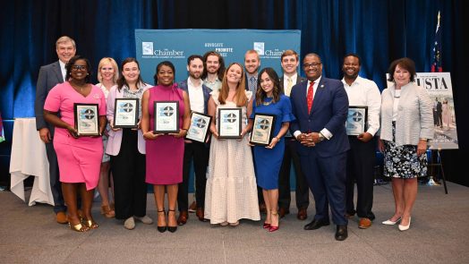 Large group of people holding awards.