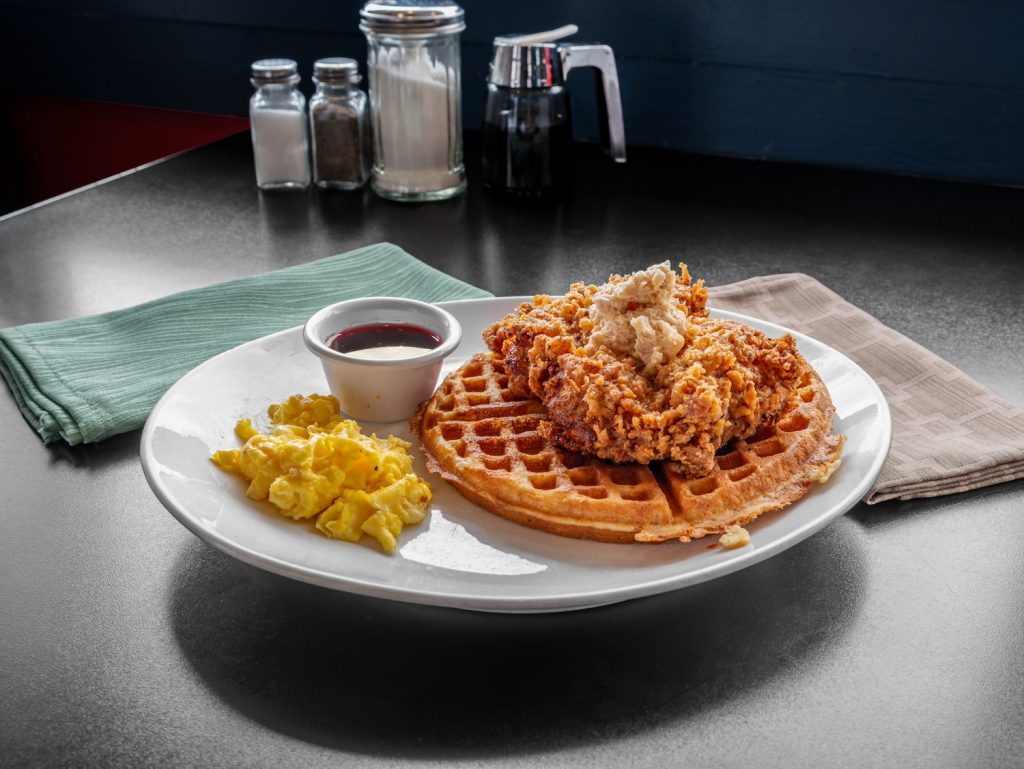 Chicken and waffles with scrambled eggs.