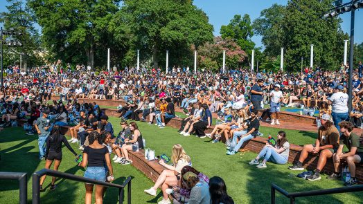 Hundreds of incoming freshman take part in Freshman Convocation on the grassy steps outside the JSAC