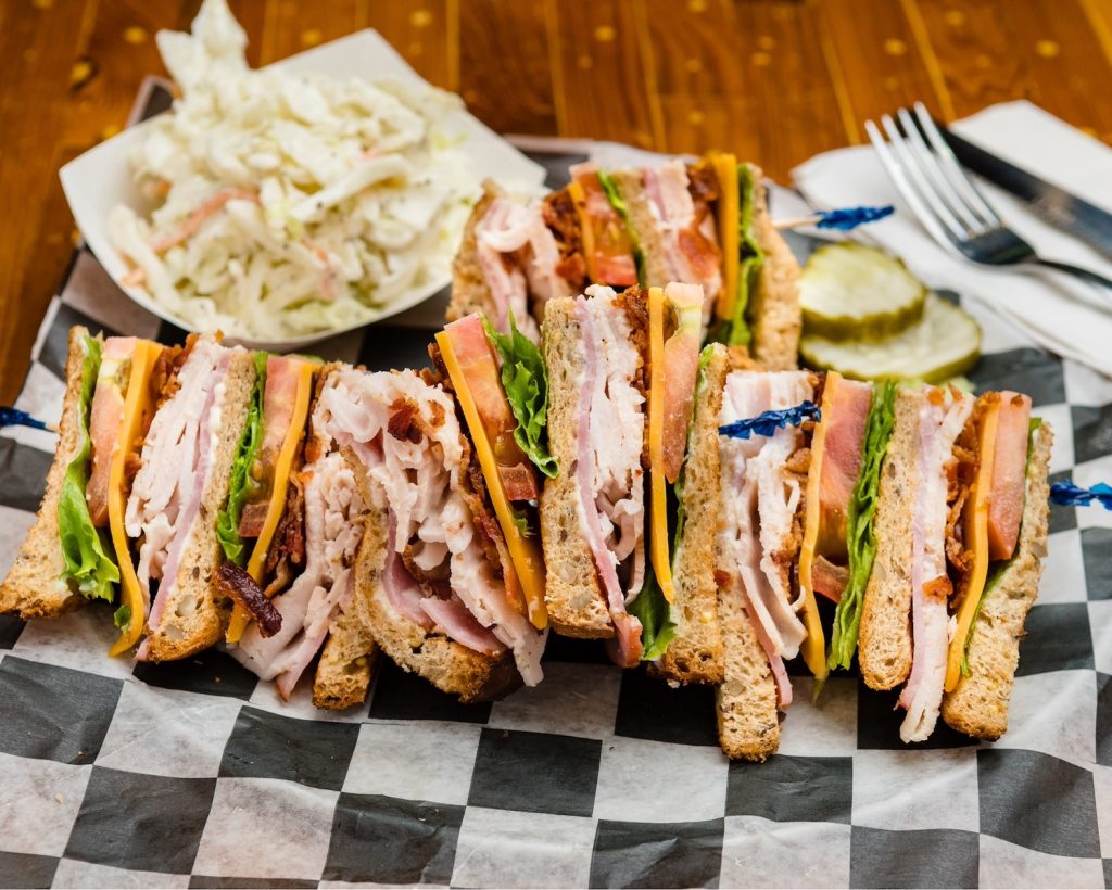 Club sandwich with a side of cole slaw.