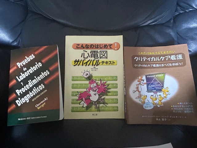 Three books written in different languages are pictured side by side.