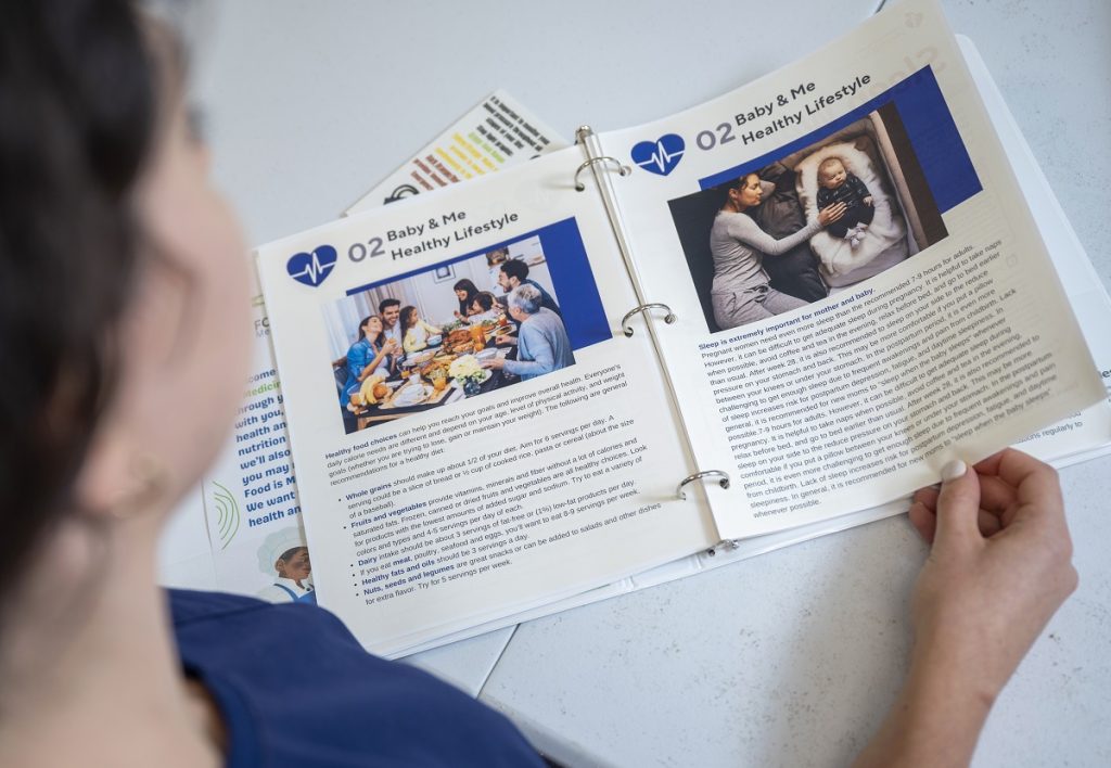 A woman reads the Food is Medicine workbook, which helps women who are expecting a child and those who are already mothers.