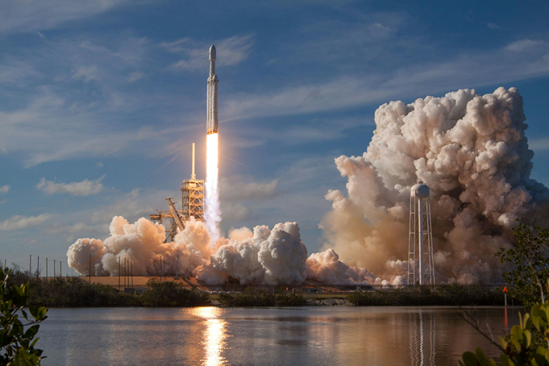 A rocket takes off from a launch pad.