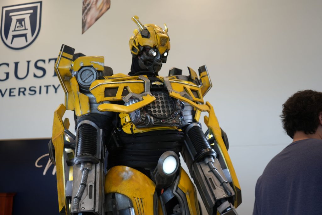 A person wears an intricate costume portraying Bumblebee from the "Transformers" franchise.