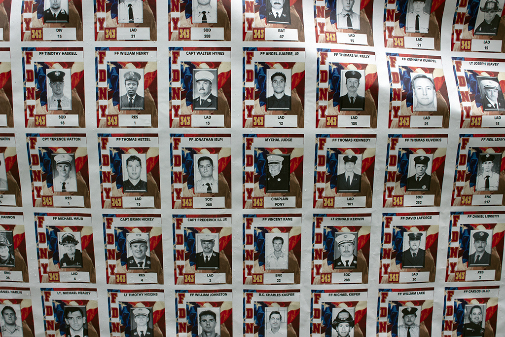 Banner displays photos of NYFD firefighters who died in the attacks of 9/11