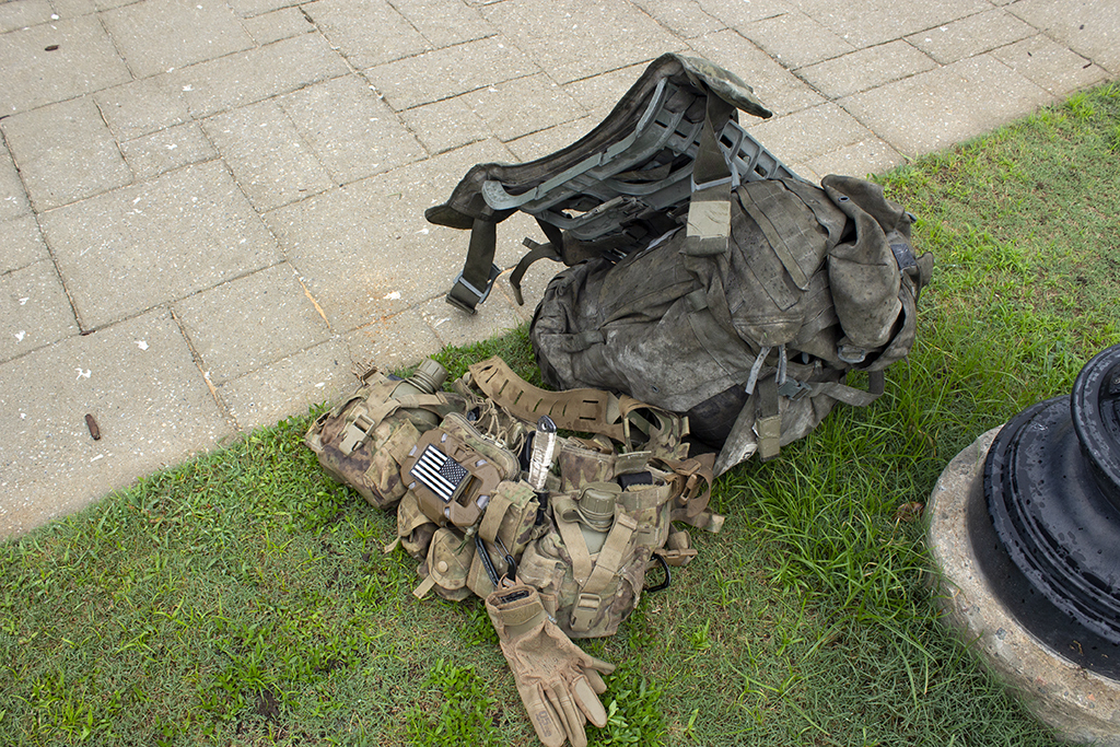 Backpack and gear sit on the ground.