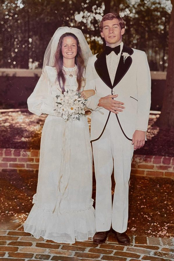 Vintage photo of a bride and groom standing outside.