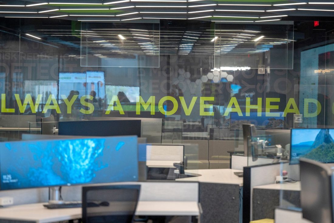 Photo of AU's cyber defense operations department. The glass wall has a slogan on it: "Always a Move Ahead."