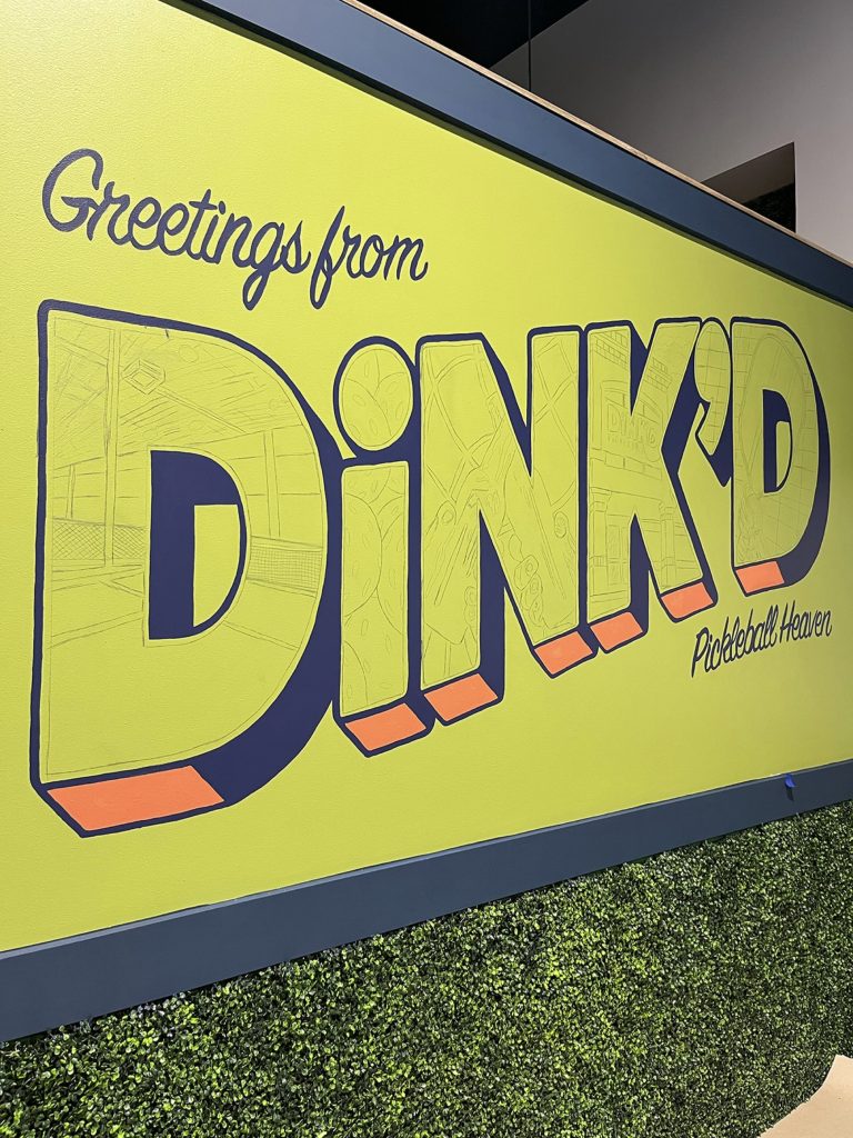 A progression of a mural in a pickleball facility with the words "Greetings from DiNK'D Pickleball Heaven."