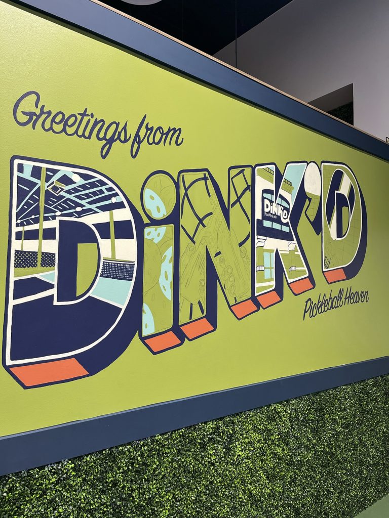 A progression of a mural in a pickleball facility with the words "Greetings from DiNK'D Pickleball Heaven." More of the letters have textures added.