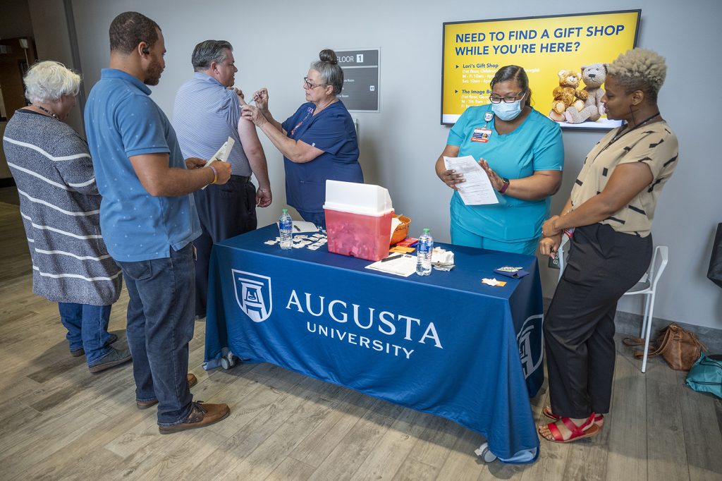 Woman giving a flu vaccine