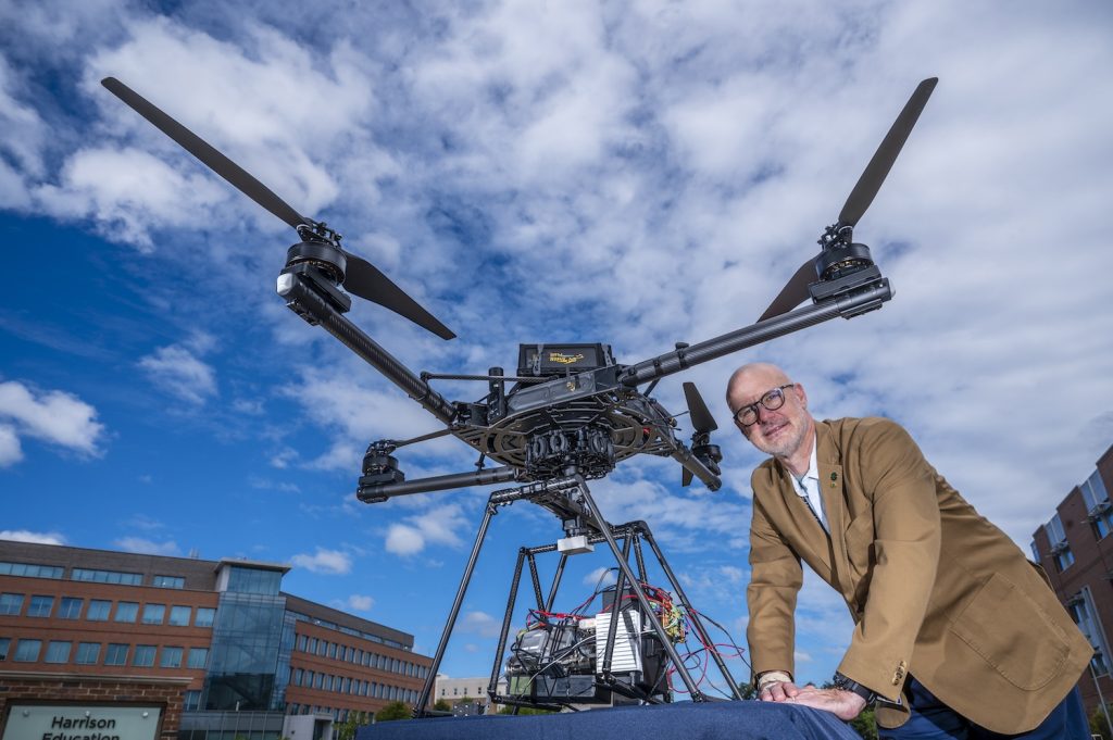 Man standing outside by a drone.