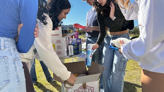 Students looking at supplies with one another