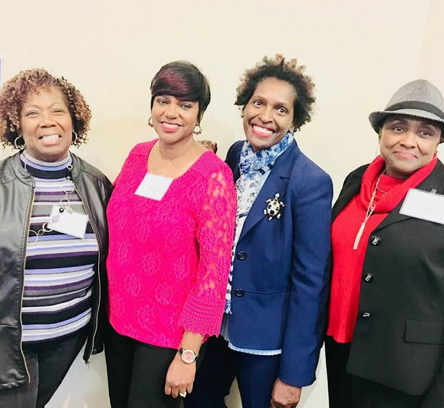 Four women smiling